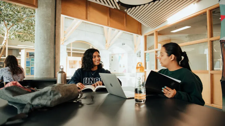 Students at a desk inside the UNBC Prince George campus