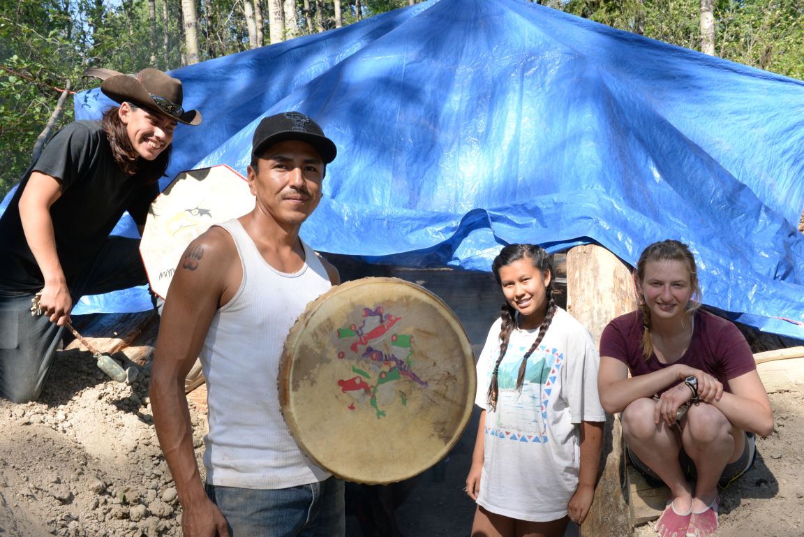 The class celebrated the first campfire inside the pit house with drumming and singing.