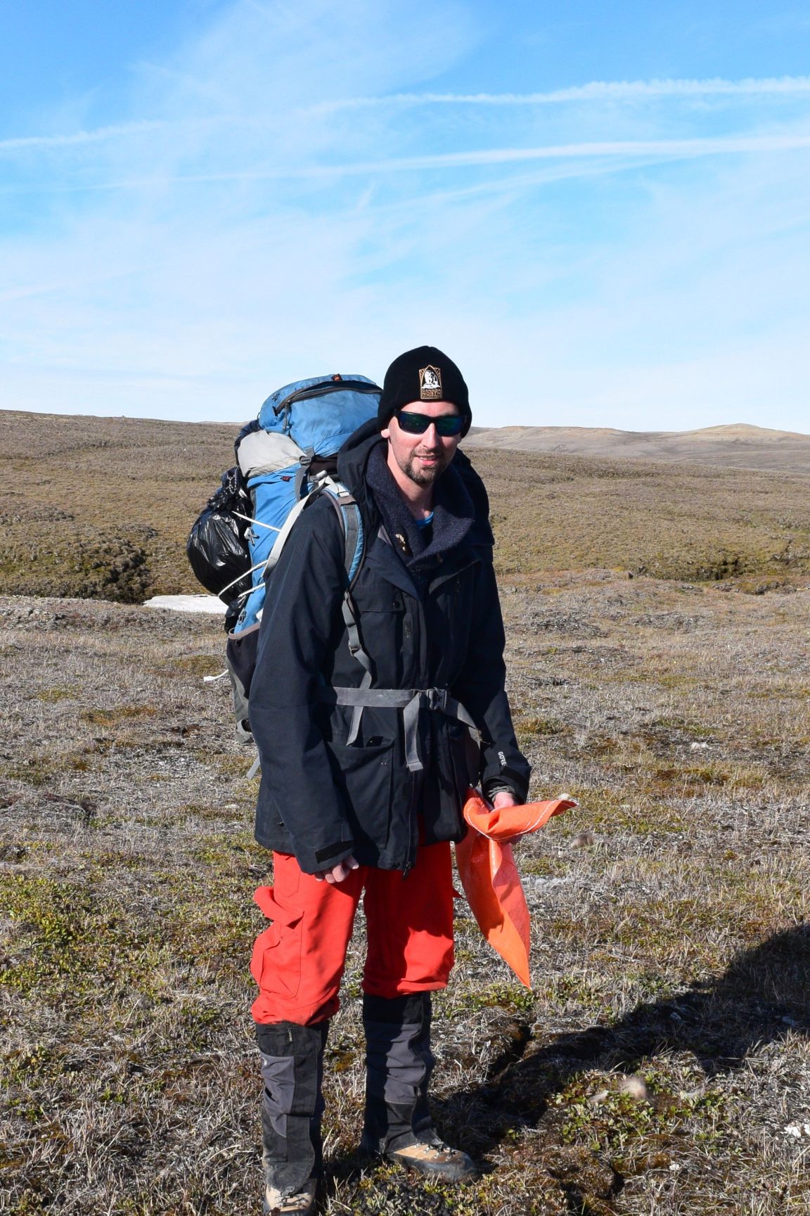 Dr. Fabien Mavrot in hiking gear with backpack