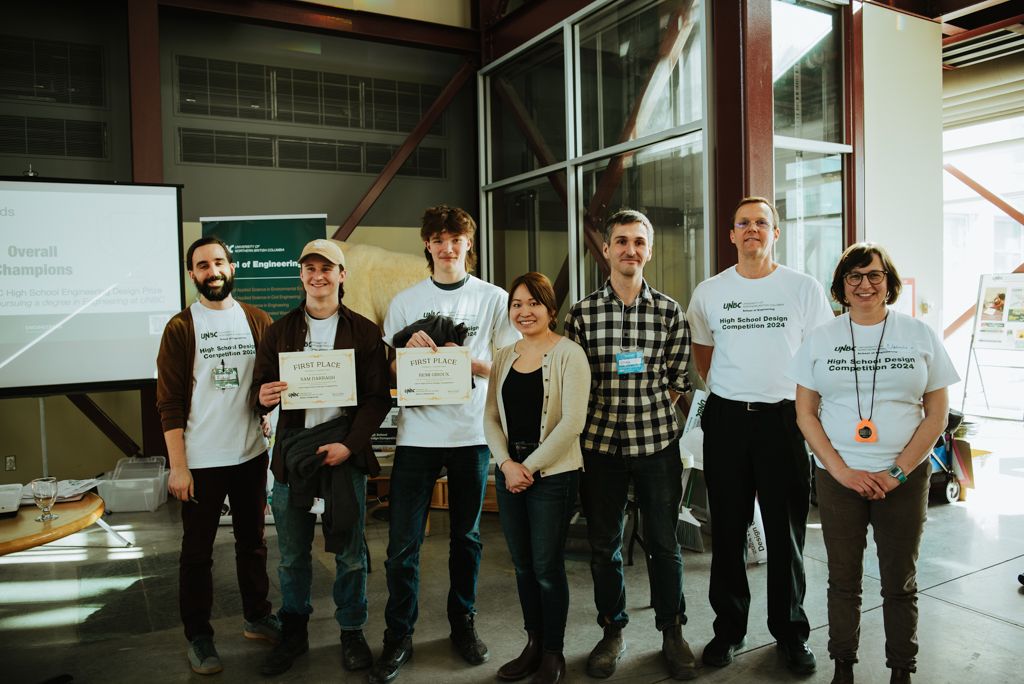 Overall winning team from Valemount Secondary School hold their award certificates and smile with competition organizers.