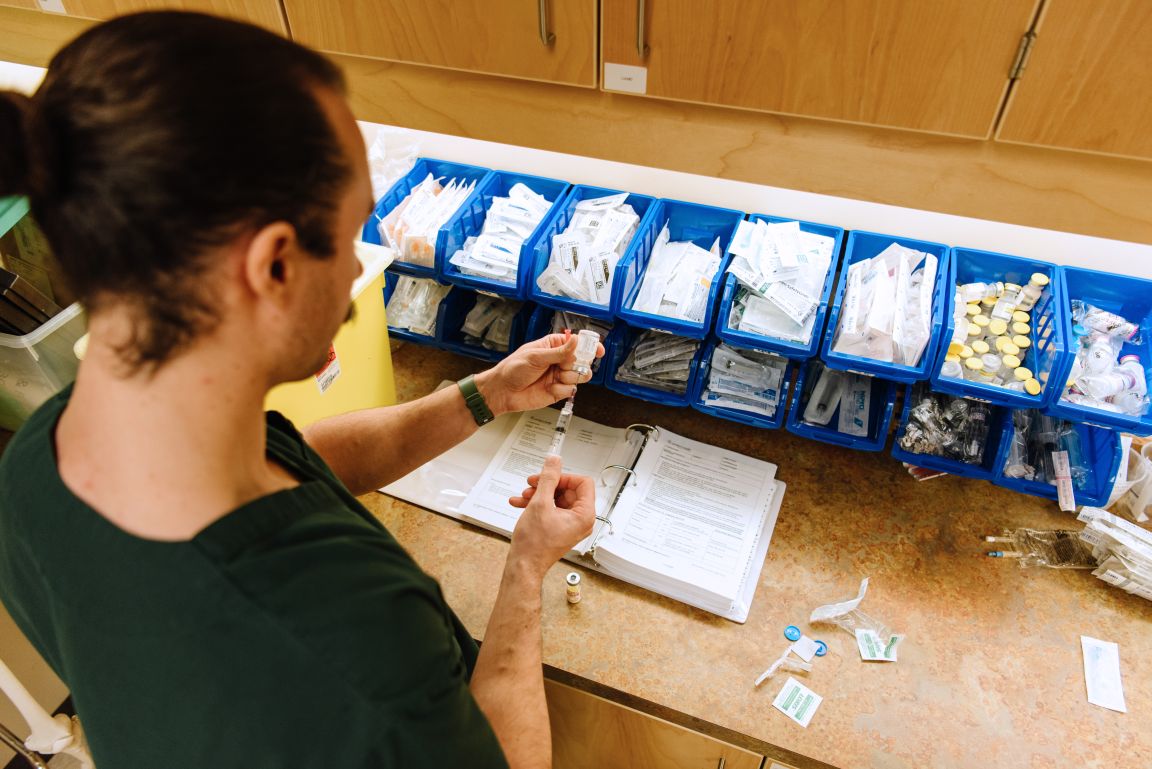 nursing student drawing medication with a syringe