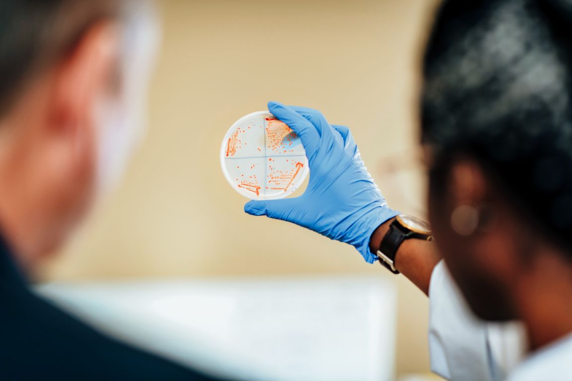 UNBC student holding a petri dish