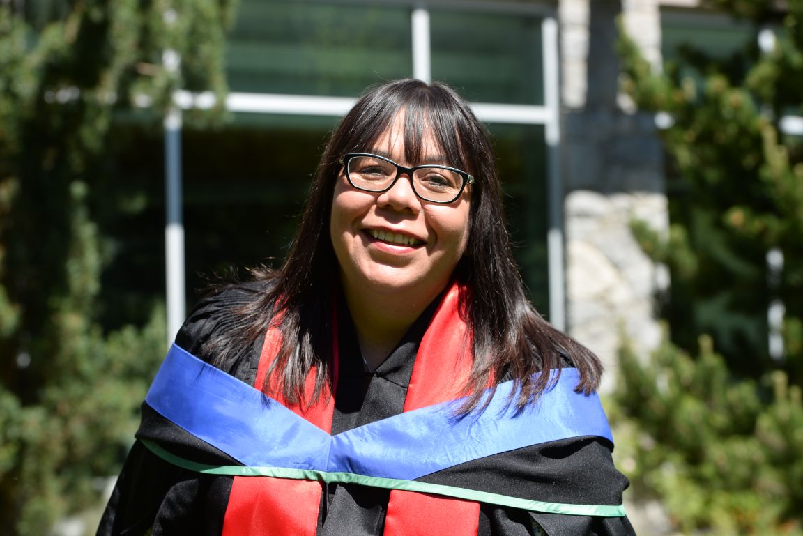 Four-time UNBC grad Bev Best in regalia in the Wabooz Garden