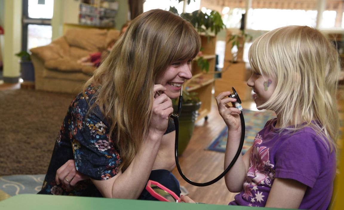 Nurse practitioner student Melanie Starzyk interacts with a child at daycare