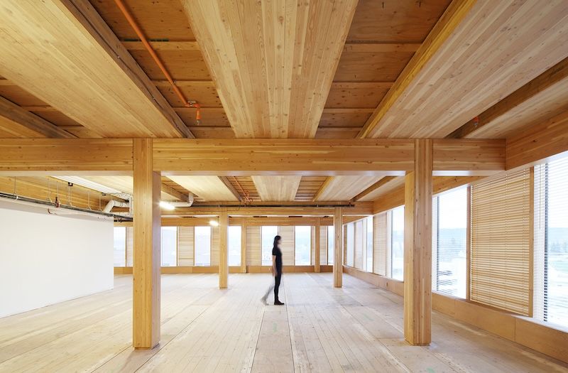 Person walking through all-wood interior of UNBC's Wood Innovation and Design Centre
