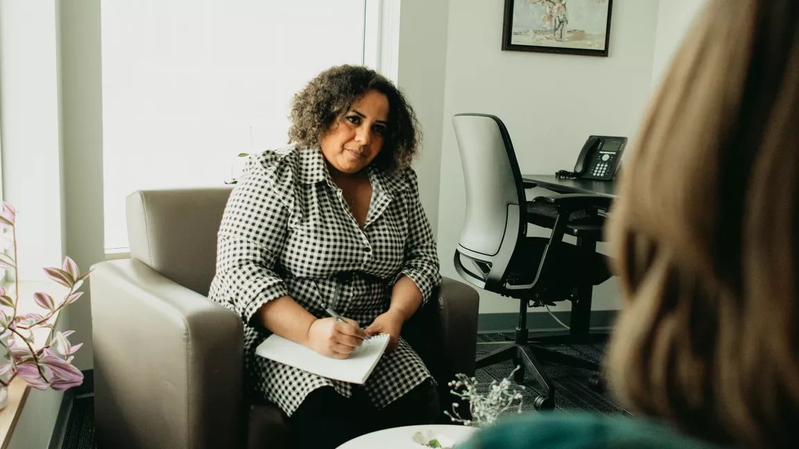 A counsellor looks attentively at a client 