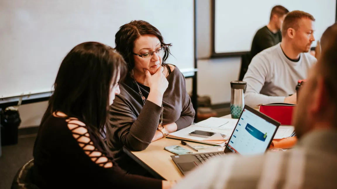 Students work together on a project in an MBA class