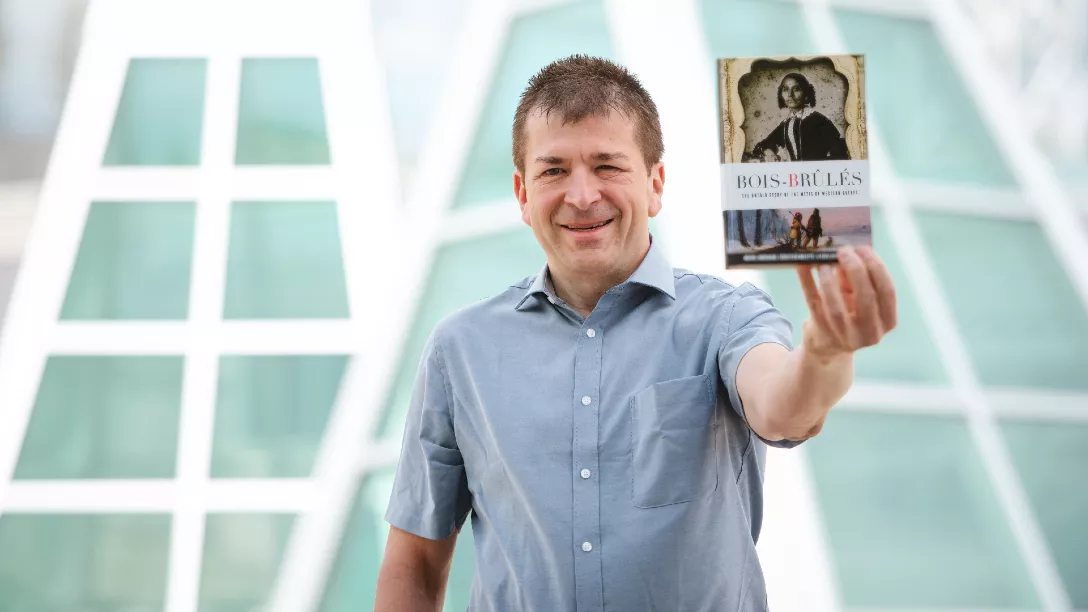 Dr. Michel Bouchard with his book Les Bois-Brûlés de l’Outaouais.