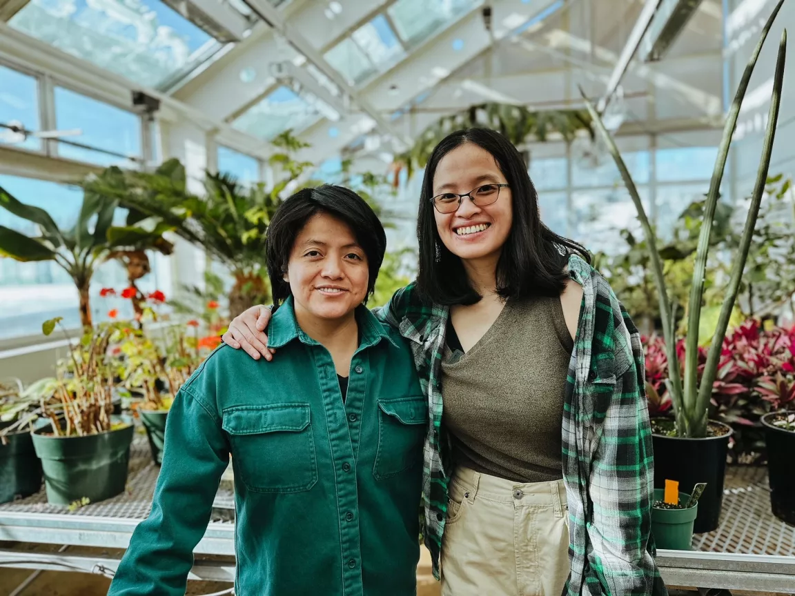 Two people in a greenhouse