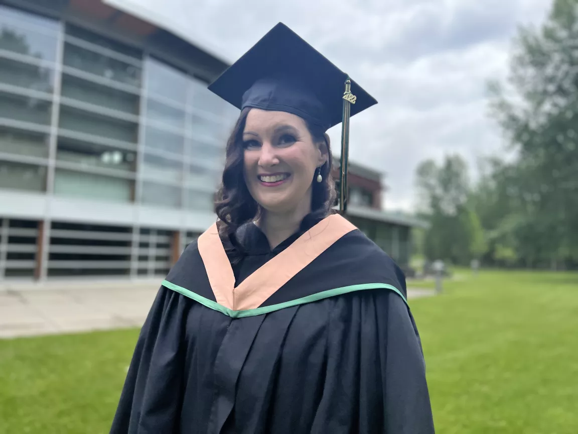 Cheri Tetreault outside the South-Central campus, in cap and gown 