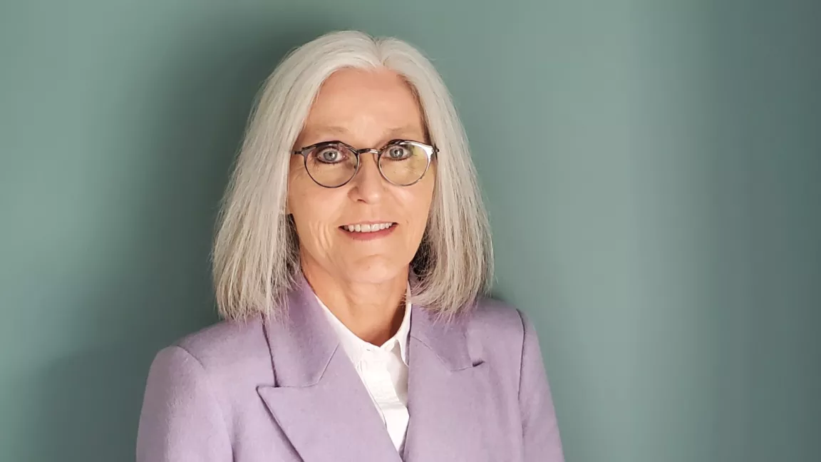 Dr. Wendy Rodgers in front of a light green wall 