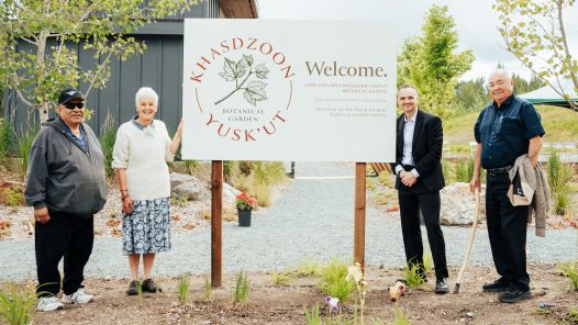 Dominic Frederick, Catriona McLenna, UNBC President Dr. Geoff Payne and Elder Barry Seymour stand on either side of the new Khasdzoon Yusk’ut Botanical Garden sign following the naming ceremony at UNBC.