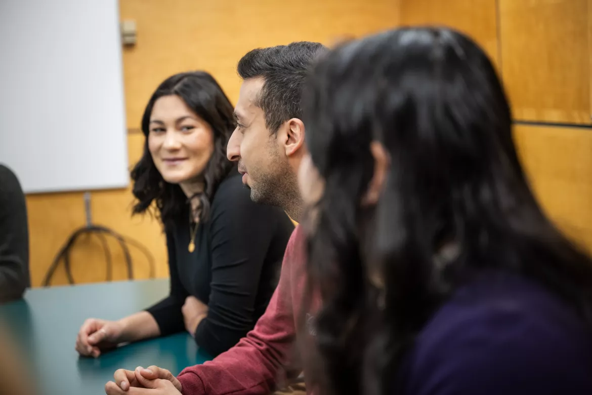 Three people having a discussion at a table