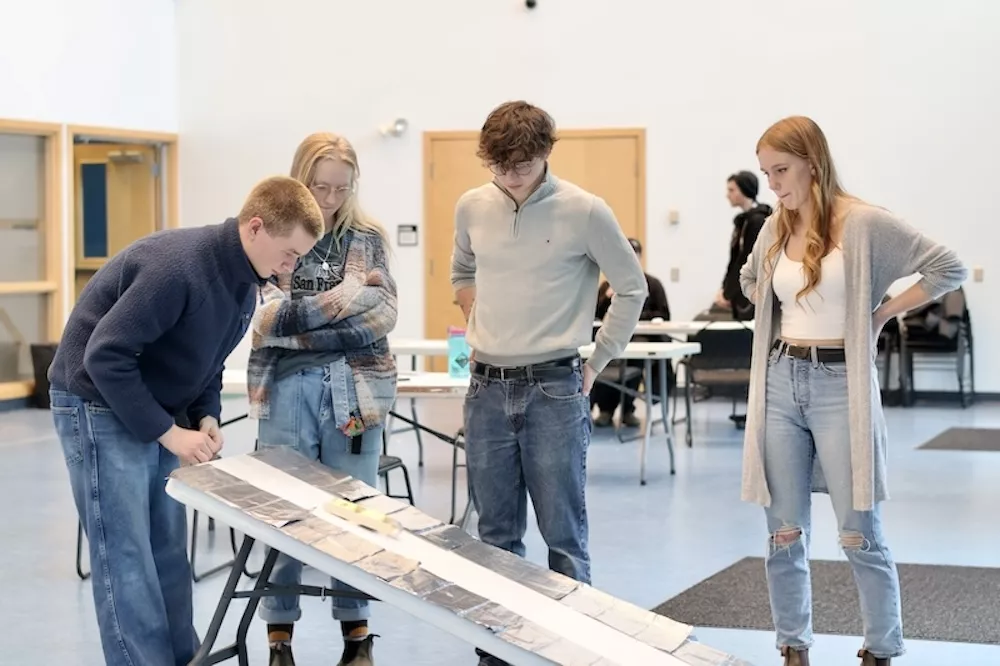 An engineering student team tests their design in an engineering competition.