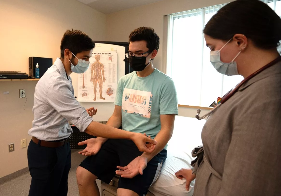 Medical students with preceptor and volunteer patient