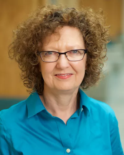 Profile photo of woman wearing turquoise blouse