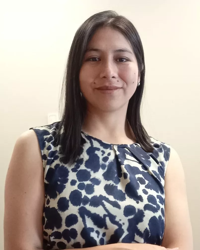 Person wearing beige and black spotted blouse.