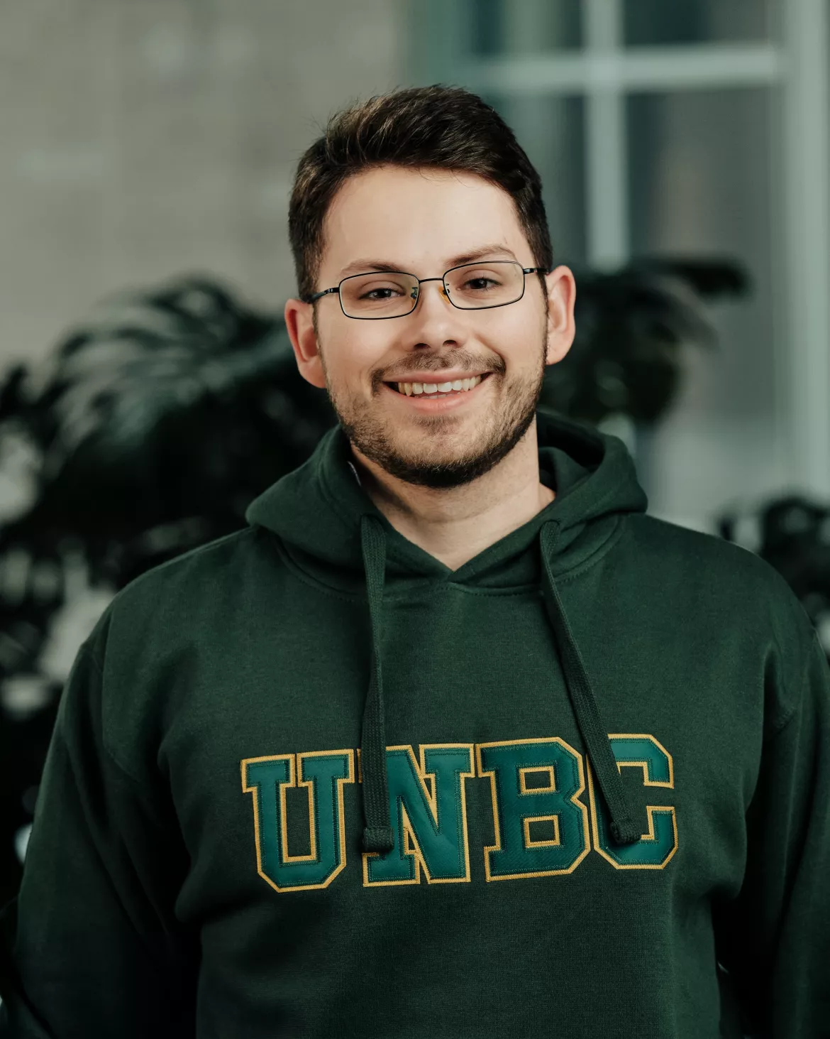 Portrait photo of Julian Stokes in a UNBC hoodie