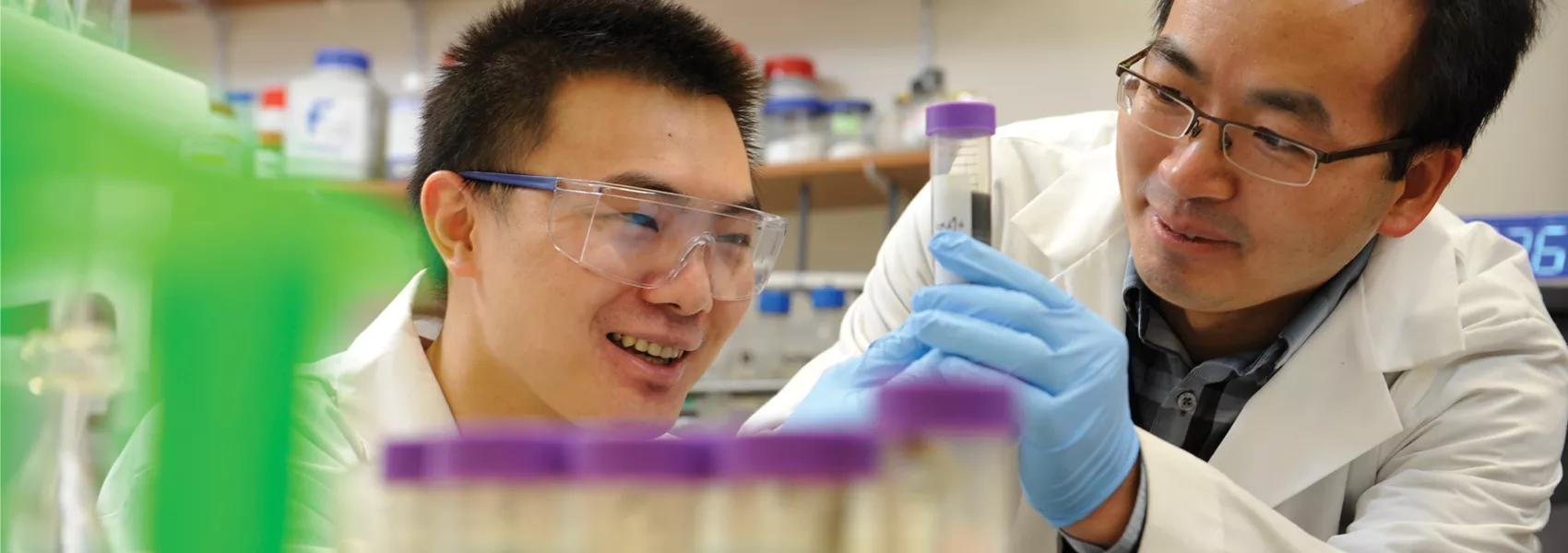 Two students viewing science equipment